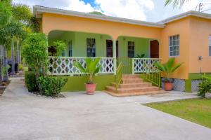 a home with a yellow and green house at DD'S Vacation Property in Harveys +2 photos