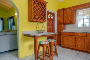 a kitchen with a counter and two stools in it at DD'S Vacation Property in Harveys
