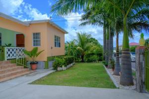 a house with palm trees and a yard at DD'S Vacation Property in Harveys