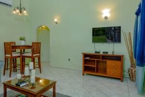 a living room with a table and a tv at DD'S Vacation Property in Harveys