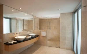 a bathroom with two sinks and a shower at Holiday Inn Sydney Potts Point in Sydney +141 photos
