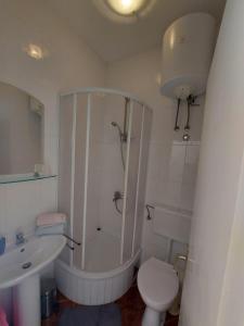 a bathroom with a shower and a toilet and a sink at Apartments by the sea Duce, Omis - 2731 in Dugi Rat +24 photos