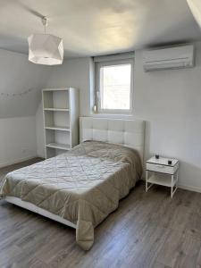 Posteľ alebo postele v izbe v ubytovaní Appartement F5 maison de maitre