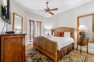 a bedroom with a bed and a ceiling fan at Villa by the Sea in Destin