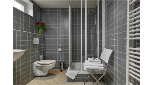a bathroom with a shower and a toilet and a sink at Mostecká 12 Residence in Prague