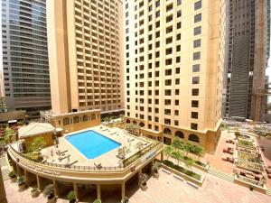 an overhead view of a building with a swimming pool at The beach hostel Dubai in Dubai
