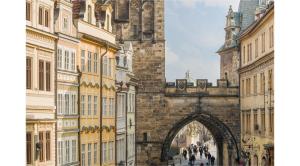 an archway in the middle of a city with buildings at Mostecká 12 Residence in Prague