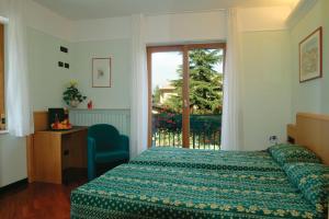 Ένα ή περισσότερα κρεβάτια σε δωμάτιο στο Hotel Ristorante Costa