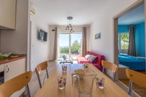 a kitchen and living room with a table and chairs at Apartment Asja in Ivan Dolac