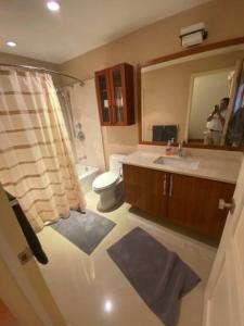 a bathroom with a sink and a toilet and a mirror at Best Vacation rental house close to Kahala Beach ! in Honolulu