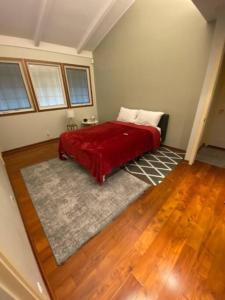 a bedroom with a bed with a red blanket at Best Vacation rental house close to Kahala Beach ! in Honolulu