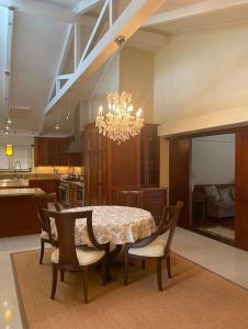 a dining room table with chairs and a chandelier at Best Vacation rental house close to Kahala Beach ! in Honolulu