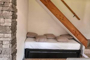 uma cama num quarto com uma parede de tijolos em Casa AICU em Villa La Angostura