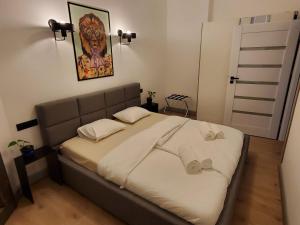 a bedroom with a large bed with white sheets at Gdanska 16 in Bydgoszcz
