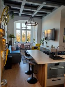 a kitchen and living room with a table and chairs at Gdanska 16 in Bydgoszcz