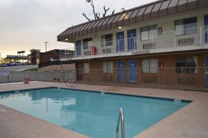 a large swimming pool in front of a building at Travelodge by Wyndham San Antonio Lackland AFB North in San Antonio