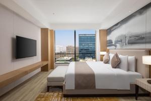 Postel nebo postele na pokoji v ubytování Metropark Hotel Hongqiao Shanghai