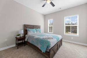 a bedroom with a bed and a ceiling fan at New 4 Bedroom Townhouse at Barefoot Resort in North Myrtle Beach