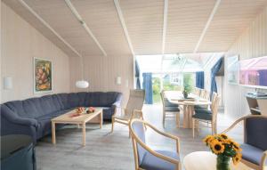 a living room with a blue couch and a table at Strandblick 7 - Dorf 1 in Travemünde