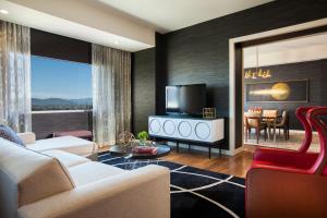 a living room with a couch and a tv at Kimpton Hotel Palomar Phoenix Cityscape, an IHG Hotel in Phoenix