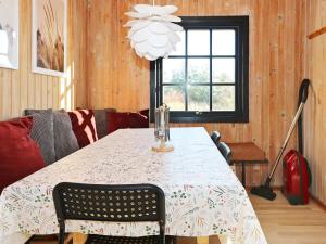 a dining room with a table and a chandelier at Renovated Retreat in Als Odde - By Traum Ferienwohnungen in Hadsund +29 photos