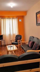 a living room with two couches and a table at The Little House ApartHotel in Uyuni