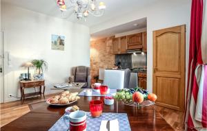 a kitchen with a table with fruits and vegetables on it at Le Logis in Sarlat-la-Canéda