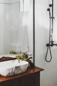 a bathroom with a marble sink and a shower at Millers Nook - Central Charm in Albury