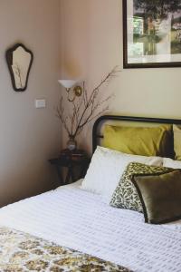 a bedroom with a bed with a white comforter at Millers Nook - Central Charm in Albury