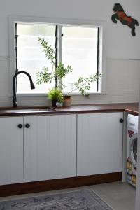 a kitchen counter with a sink and a window at Millers Nook - Central Charm in Albury