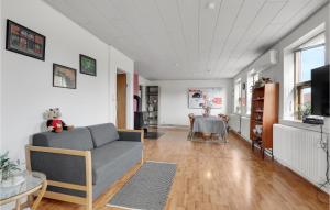 a living room with a couch and a table at Lovely Home In Aakirkeby With Kitchen in Vester Sømarken