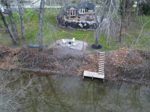 een witte bank in het water naast een huis bij Disconnect From Reality/ River House/Hot Tub/Pet Friendly in Port Burwell