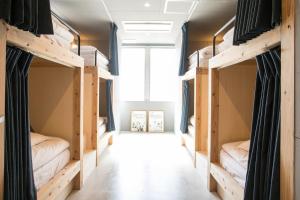 a room with four bunk beds in it at Hostel STAND BY ME in Fukuoka
