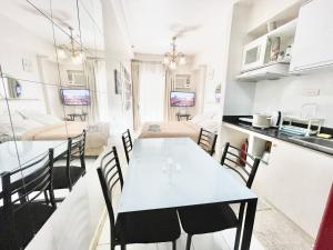 a kitchen and living room with a table and chairs at Camella Northpoint Condo Studio in Davao City