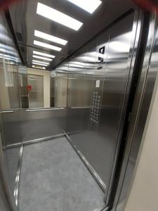 an empty room with a shiny metal appliance at m2 Tbilisi Central Park Apartment in Tbilisi City