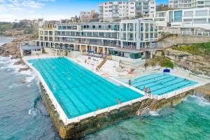 an overhead view of a swimming pool next to the ocean at Beach-side North Bondi in Sydney
