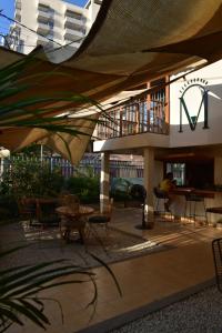 a patio with tables and chairs and a building at Hostal Magdalena in Santa Marta