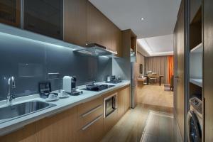 a kitchen with a sink and a counter top at Primus Residence Shanghai Hongqiao in Shanghai