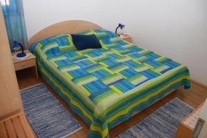 a bed in a room with two rugs at Apartments Frano in Mirce