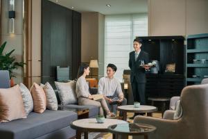 a group of people sitting in a living room at Primus Residence Shanghai Hongqiao in Shanghai