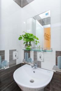 a bathroom with a white sink and a mirror at MTV Homestay Vũng Tàu in Vung Tau