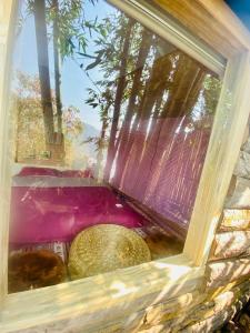 a window of a building with trees in the background at Hoàng Gia Trang in Da Lat