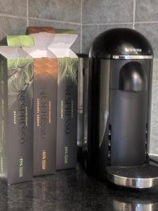 a coffee pot and three books on a counter at Holybush Bethnal Green in London
