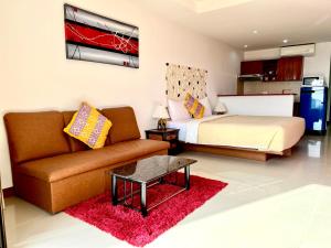 a living room with a couch and a bed at Mountain Seaview Luxury Apartments in Kata Beach