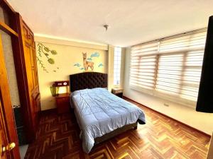 Rúm í herbergi á Cusco House Inn Hostel