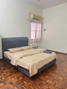 a large bed in a room with a wooden floor at Batu Pahat Airbnb Homestay Empire 15 in Batu Pahat