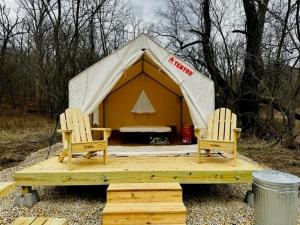 two chairs and a tent with a dog in it at Tentrr Signature Site - Maramec Spring Park McDole's Meadow in Saint James