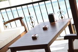 a wooden table sitting on top of a balcony at Apollon Hotel in Patara