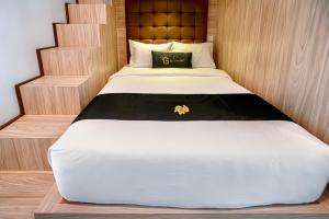 Postel nebo postele na pokoji v ubytování Graha Socio Hotel Nusa Dua Bali