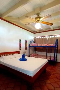 a bedroom with two bunk beds and a ceiling fan at Hotel Las Palmas in Coco